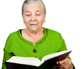 Amazed senior woman reading surprise book