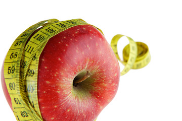 Ripe red apple with measuring tape