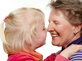 Granddaughter and grandmother touching their nose