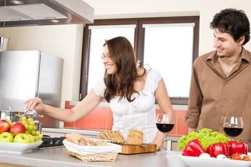 Obraz na płótnie Canvas Happy couple cook together in modern kitchen