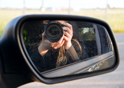 Driving mirror with photographer reflection.
