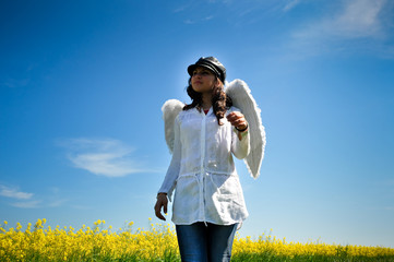 girl with white wings  in a  yellow field
