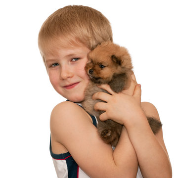 Portrait of a smiling boy with a little puppy