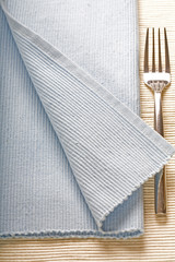 fork on blue napkin