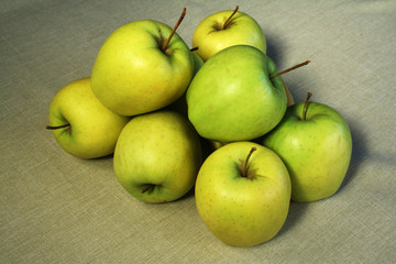Group of green apples on a linen cloth