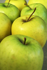 Some green apples standing in numbers