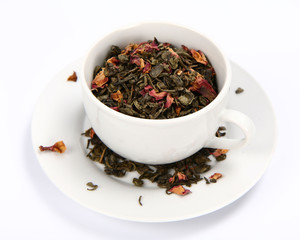 Cup filled with dried green tea leaves and rose petals