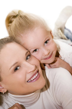 Mother and daughter posing happily. Focus on mother.