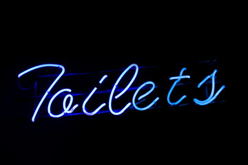Blue neon toilets sign