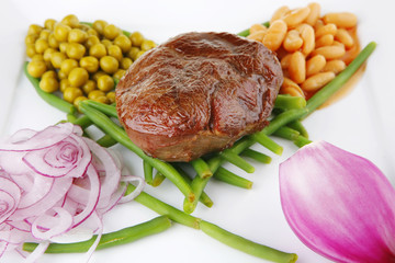 served meat medalion on beans