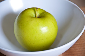 Green apple in a bowl