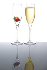 Two sparkling wine glasses with a strawberry