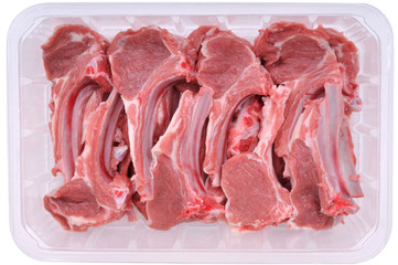 Supermarket packaged raw lamb chops isolated on white