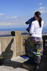 Woman looking through a coin operated binoculars