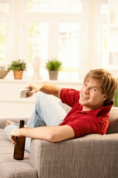 Man on sofa with remote control