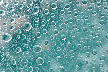 Water bubbles on a green glass. Abstract background
