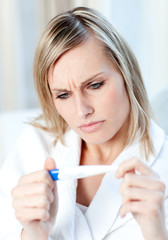 Worried woman finding out the results of a pregnancy test