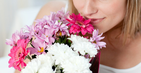 Obraz na płótnie Canvas Close-up of a woman smelling a bunch of flowers