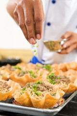 Sprinkle herbs on noodle
