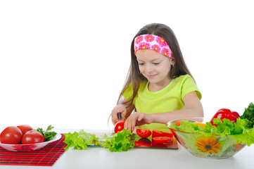 little girl is preparing salad