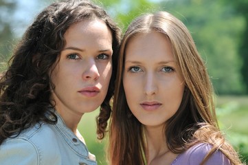 Portrait of two young woman (teenage girls)