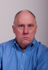 Obraz premium Old Bald Man with Angry Expression