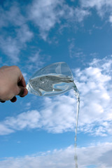 glass of water against a cloudy sky