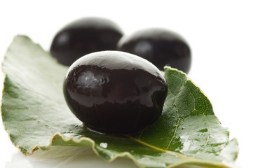 black olives over leaf close up