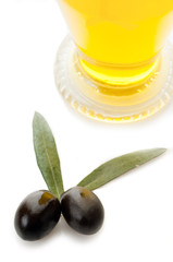 black olives with leaf and bottle of oil
