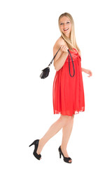 Isolated caucasian blond woman in red dress