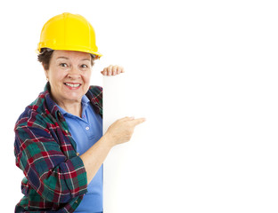 Female Worker Points at Sign