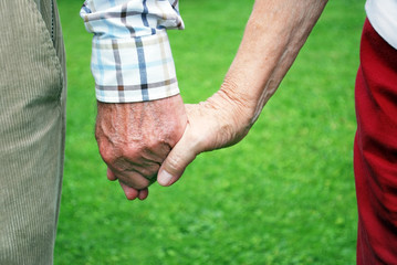 senior couple holding hands