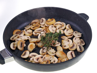 braised mushrooms in a pan isolated on white background