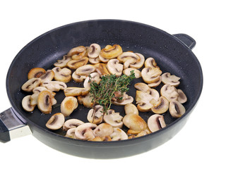 cooking mushrooms in a pan isolated on white background