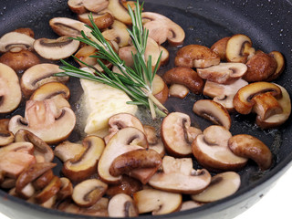 sauteed brown champignon, butter & herb in black pan