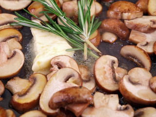 braised mushrooms, butter & herb in a black pan
