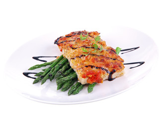 baked fish with vegetables isolated on white background