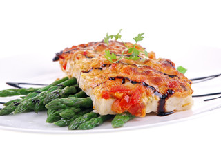 baked fish with vegetables isolated on white background