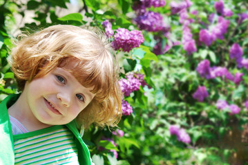 Fototapeta premium little girl in lilac garden