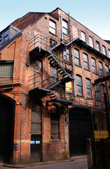 Old building with fire escape stairs, Manchester, UK