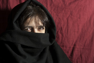 Woman's face covered by burka
