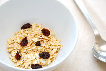 Small serving of healthy oatmeal and raisins