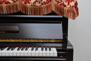 Upright piano with open view of keyboard