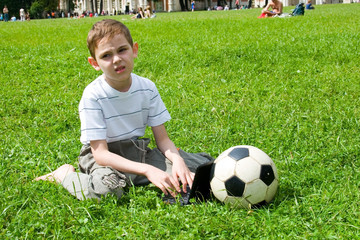 Obraz premium Boy with a laptop and a soccer ball