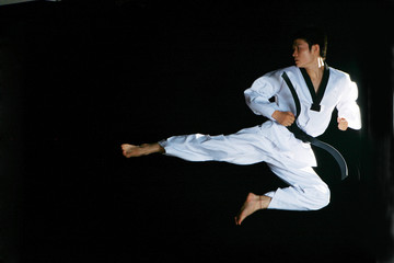 one asian man is playing with taekwondo - obrazy, fototapety, plakaty
