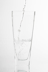 Glass of water half empty isolated on white background ..