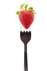 Strawberry on fork isolated on white