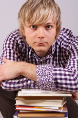 young man with books, reading and studying