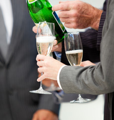 Close-up of a business person serving Champagne