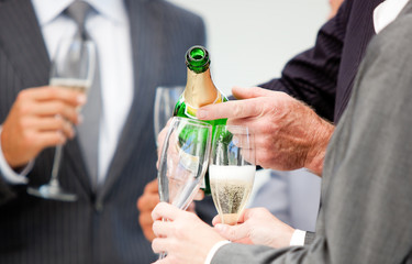 Close-up of a businessman serving Champagne